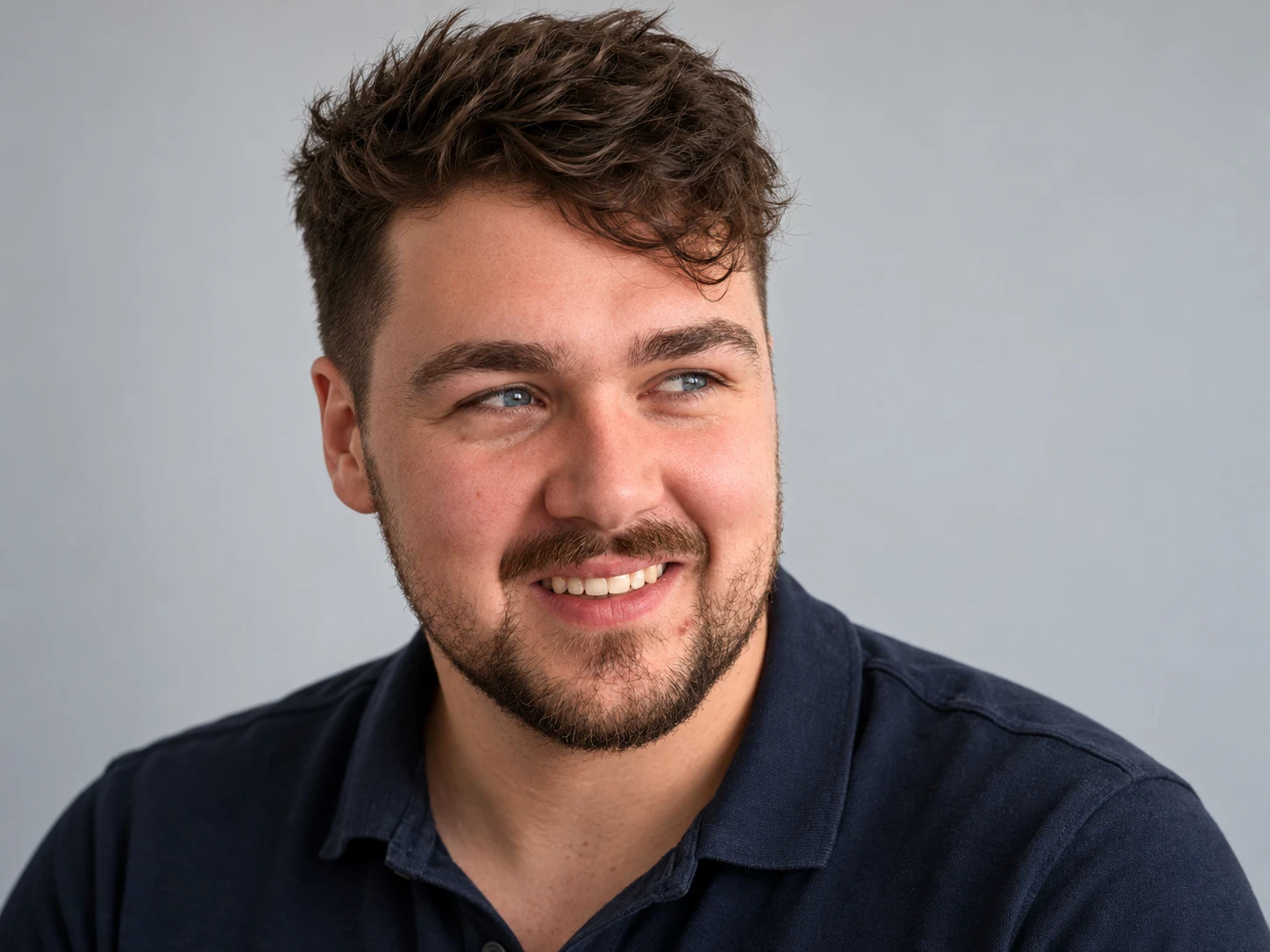 Man met wat langer haar bovenop dat als een losse lok schuin over zijn voorhoofd valt